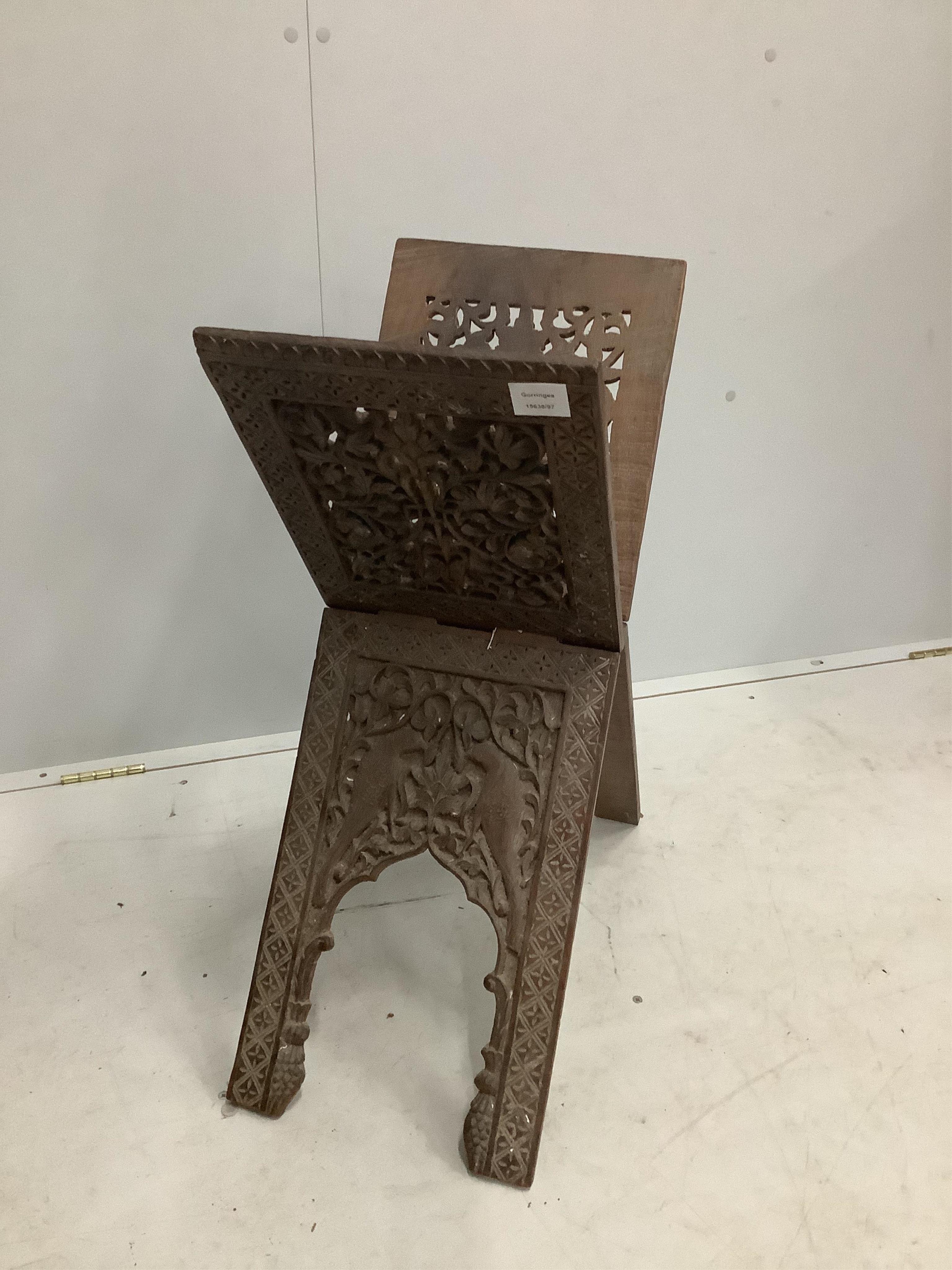 A carved wood Koran stand, width 57cm, height 73cm. Condition - fair